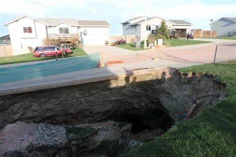 Giant sinkholes in a South Dakota neighborhood make families fear for their safety