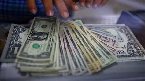 Dollar slides to three-year low after Trump repeats tariff threats