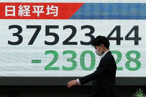 Asian shares slide and US futures and dollar drop after Moody's downgrade of US credit rating