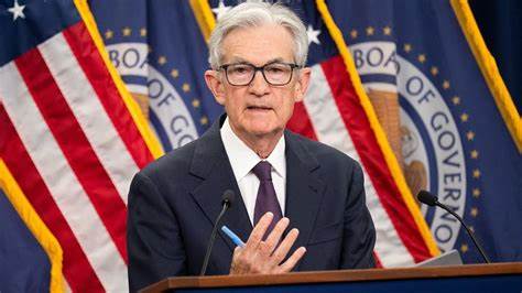 Fed holds key rate steady, still sees two more cuts this year