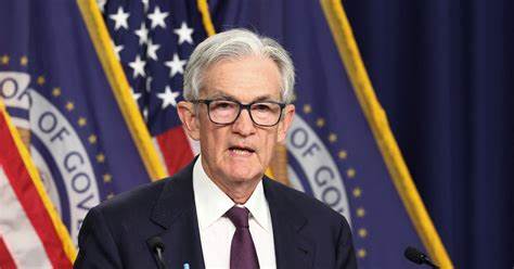 Fed sees rising risks to economy as it leaves rates unchanged